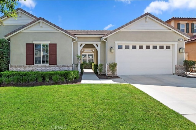 27843 Huron Ct, Menifee, CA 92585 - view of front of property featuring brick siding, a front lawn, an attached garage, driveway, and stucco siding