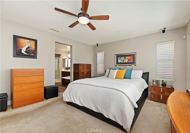 27843 Huron Ct, Menifee, CA 92585 - bedroom with light colored carpet, a ceiling fan, and ensuite bathroom