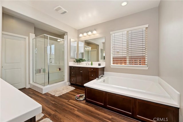 27843 Huron Ct, Menifee, CA 92585 - full bathroom featuring a stall shower, a bath, vanity, and wood finished floors