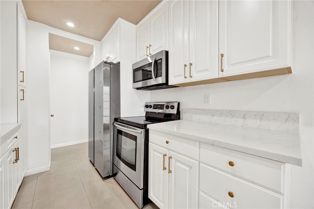 5320 Zelzah Ave Unit 106, Encino, CA 91316 - kitchen featuring appliances with stainless steel finishes, white cabinetry, light tile patterned floors, light stone counters, and recessed lighting