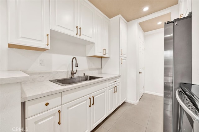 5320 Zelzah Ave Unit 106, Encino, CA 91316 - kitchen featuring appliances with stainless steel finishes, white cabinets, light tile patterned floors, recessed lighting, and light stone counters