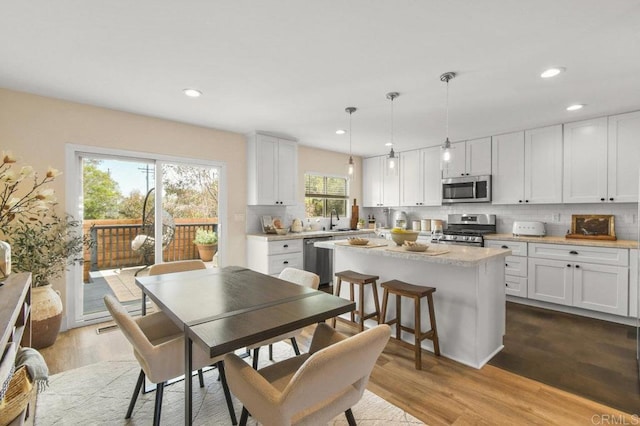 3585 Redwood St, San Diego, CA 92104 - dining room with wood finished floors and recessed lighting