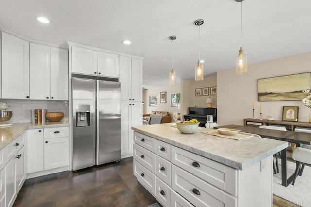 3585 Redwood St, San Diego, CA 92104 - kitchen with stainless steel fridge with ice dispenser, white cabinets, tasteful backsplash, decorative light fixtures, and open floor plan