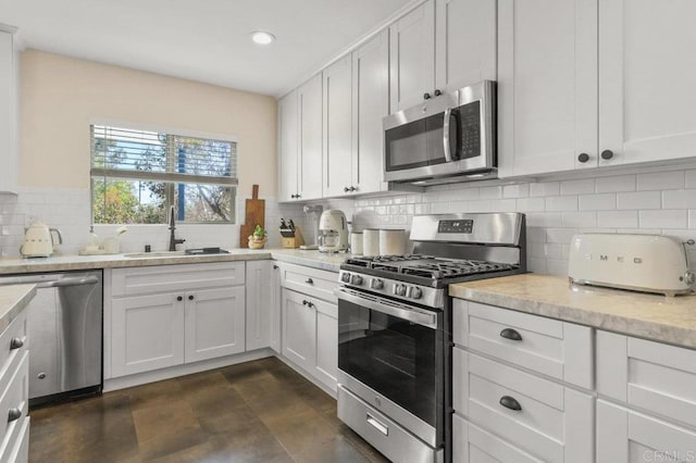 3585 Redwood St, San Diego, CA 92104 - kitchen with stainless steel appliances, decorative backsplash, recessed lighting, white cabinetry, and light stone countertops