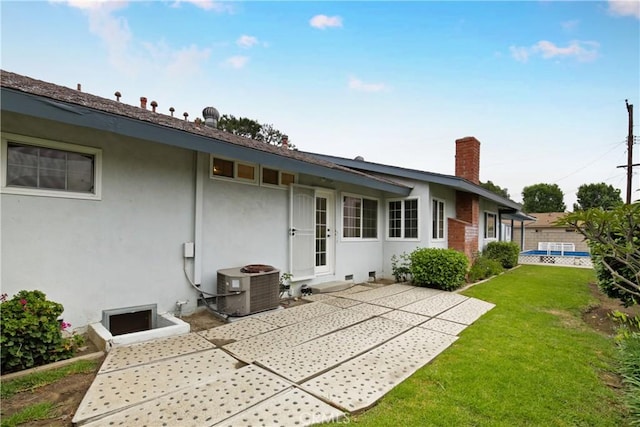 13924 2nd St, Whittier, CA 90605 - back of house with a yard, stucco siding, a patio, and a chimney