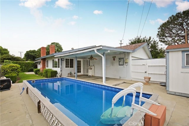 13924 2nd St, Whittier, CA 90605 - back of house featuring a chimney, a patio area, a ceiling fan, and a gate