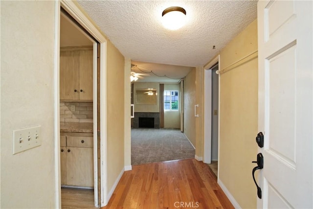 13924 2nd St, Whittier, CA 90605 - corridor featuring a textured ceiling and light wood-style flooring