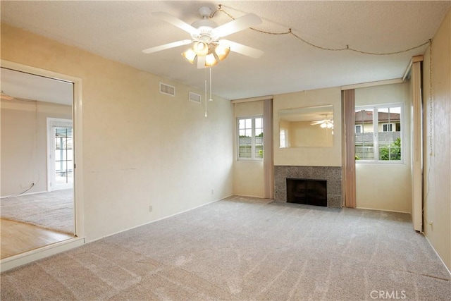 13924 2nd St, Whittier, CA 90605 - unfurnished living room with ceiling fan, healthy amount of natural light, carpet flooring, and a tiled fireplace