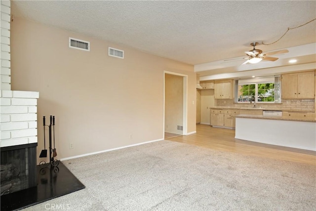 13924 2nd St, Whittier, CA 90605 - unfurnished living room with light carpet, a ceiling fan, a textured ceiling, and a fireplace
