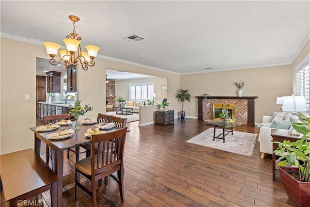 15037 Hiawatha St, Mission Hills San Fernando, CA 91345 - dining area featuring dark wood-type flooring, ornamental molding, a chandelier, and a premium fireplace