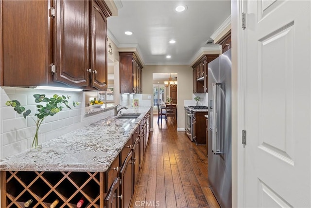 15037 Hiawatha St, Mission Hills San Fernando, CA 91345 - kitchen featuring appliances with stainless steel finishes, dark wood-style floors, tasteful backsplash, crown molding, and recessed lighting
