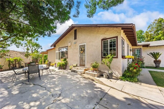 822 Corona Ave, Corona, CA 92879 - back of house with stucco siding, a patio, and outdoor dining space