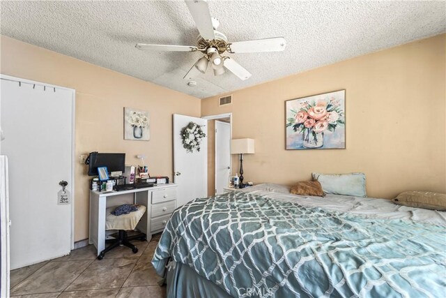 822 Corona Ave, Corona, CA 92879 - tiled bedroom featuring a textured ceiling, ceiling fan, and a desk