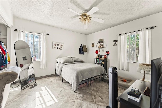 822 Corona Ave, Corona, CA 92879 - bedroom with light marble finish floors, a textured ceiling, and ceiling fan