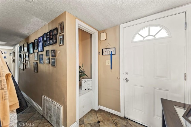 822 Corona Ave, Corona, CA 92879 - tiled entryway featuring a textured ceiling and baseboards