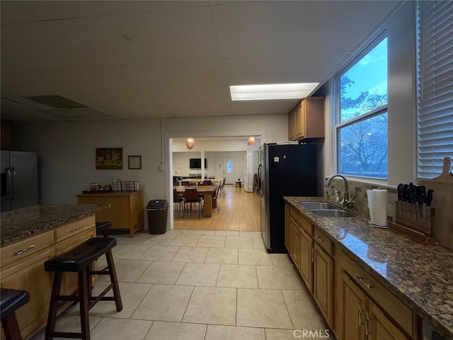 24145 Tokayana Way, Colfax, CA 95713 - kitchen featuring freestanding refrigerator, brown cabinetry, and dark stone countertops