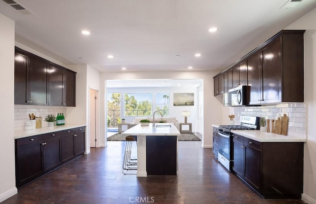26370 Piazza Di Sarro, Newhall, CA 91321 - kitchen featuring stainless steel appliances, dark wood-style flooring, dark brown cabinetry, recessed lighting, and light countertops