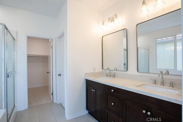 26370 Piazza Di Sarro, Newhall, CA 91321 - bathroom with a stall shower, double vanity, tile patterned floors, and a walk in closet