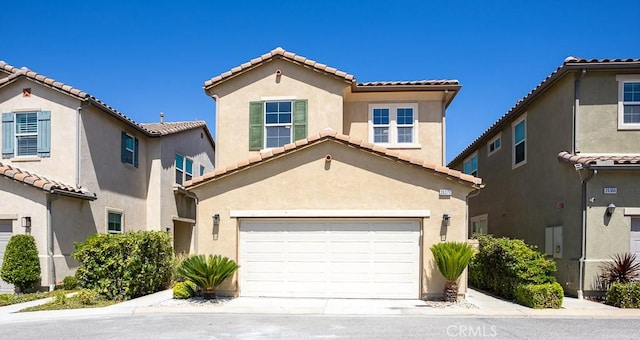 26370 Piazza Di Sarro, Newhall, CA 91321 - mediterranean / spanish-style home featuring a tile roof, stucco siding, a garage, and driveway