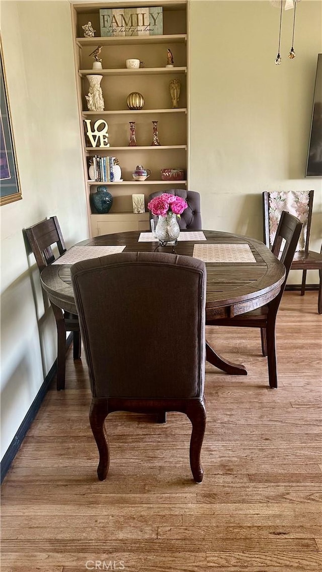 130 Cary Ln, Pomona, CA 91767 - dining space featuring wood finished floors and baseboards