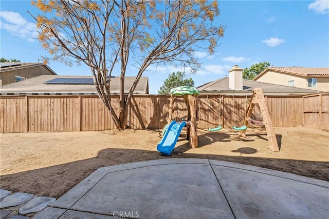 3260 Ivy Ct, Perris, CA 92571 - fenced backyard with a playground and a patio area