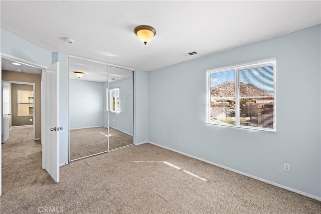 3260 Ivy Ct, Perris, CA 92571 - unfurnished bedroom with carpet flooring, multiple windows, and a closet