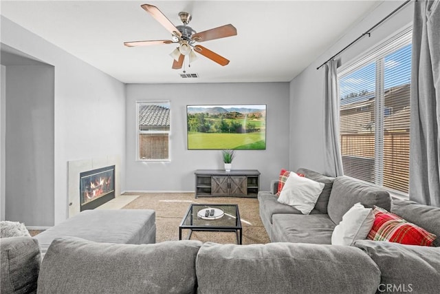 3260 Ivy Ct, Perris, CA 92571 - living room with carpet, a ceiling fan, and a fireplace with flush hearth