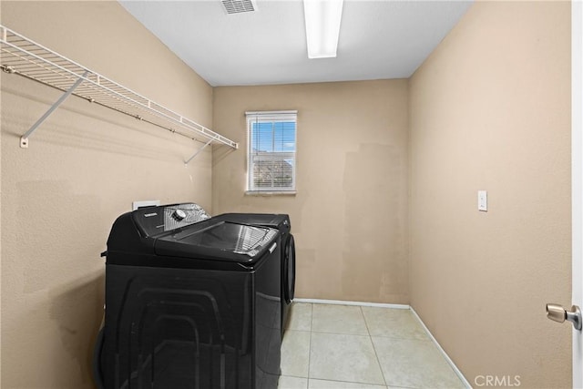 3260 Ivy Ct, Perris, CA 92571 - laundry room with separate washer and dryer and light tile patterned flooring
