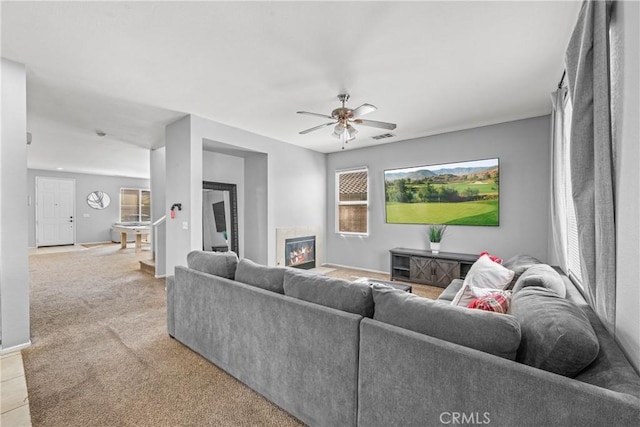 3260 Ivy Ct, Perris, CA 92571 - living area featuring a ceiling fan, a glass covered fireplace, and light colored carpet
