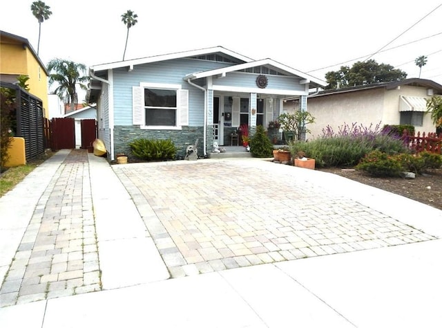 2616 S Denison Ave, San Pedro, CA 90731 - view of front of property featuring covered porch, stone siding, and driveway