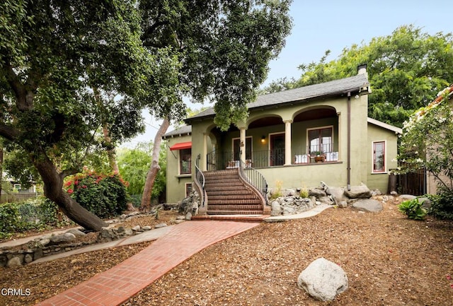413 Sycamore Pl, Sierra Madre, CA 91024 - view of front of property with a porch, stucco siding, stairway, and a chimney