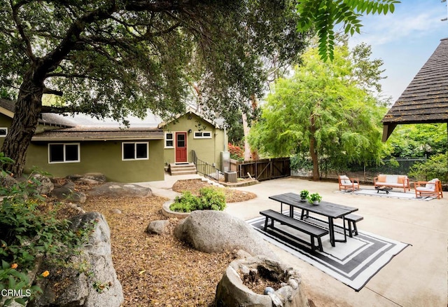 413 Sycamore Pl, Sierra Madre, CA 91024 - rear view of property with entry steps, a patio area, stucco siding, and an outdoor living space