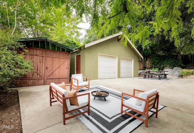 413 Sycamore Pl, Sierra Madre, CA 91024 - view of patio / terrace featuring an outdoor fire pit, a detached garage, and an outbuilding