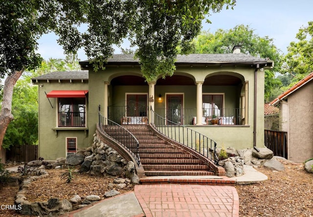 413 Sycamore Pl, Sierra Madre, CA 91024 - view of front facade with stucco siding, stairs, a porch, a chimney, and french doors