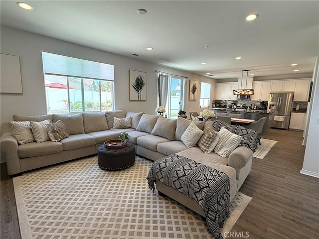 27265 Graphite Dr, Menifee, CA 92584 - living area featuring healthy amount of natural light, recessed lighting, and wood finished floors