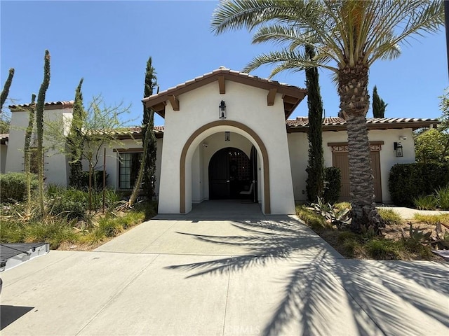 27265 Graphite Dr, Menifee, CA 92584 - view of front of house featuring a tile roof, stucco siding, and driveway