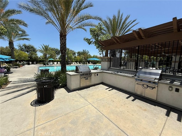 27265 Graphite Dr, Menifee, CA 92584 - view of patio with an outdoor kitchen and a community pool