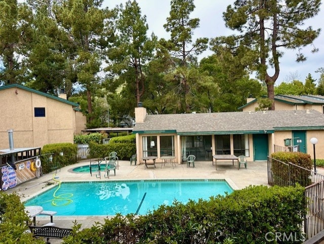 570 Peach St Unit 25, San Luis Obispo, CA 93401 - community pool featuring a patio and view of wooded area