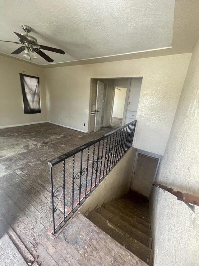 5412 Cervantes Ave, San Diego, CA 92114 - staircase with a textured ceiling, a ceiling fan, hardwood / wood-style floors, and a textured wall