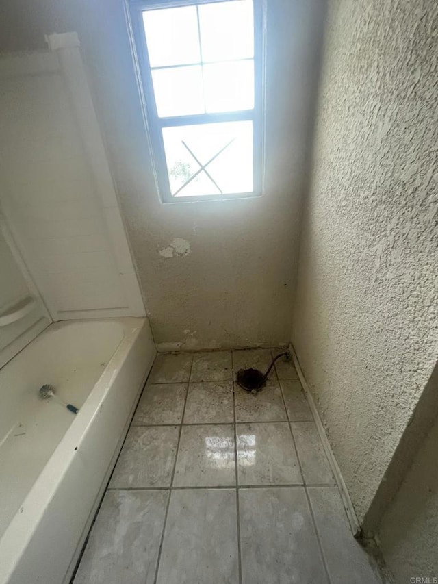 5412 Cervantes Ave, San Diego, CA 92114 - bathroom featuring a tub, a textured wall, and tile patterned floors