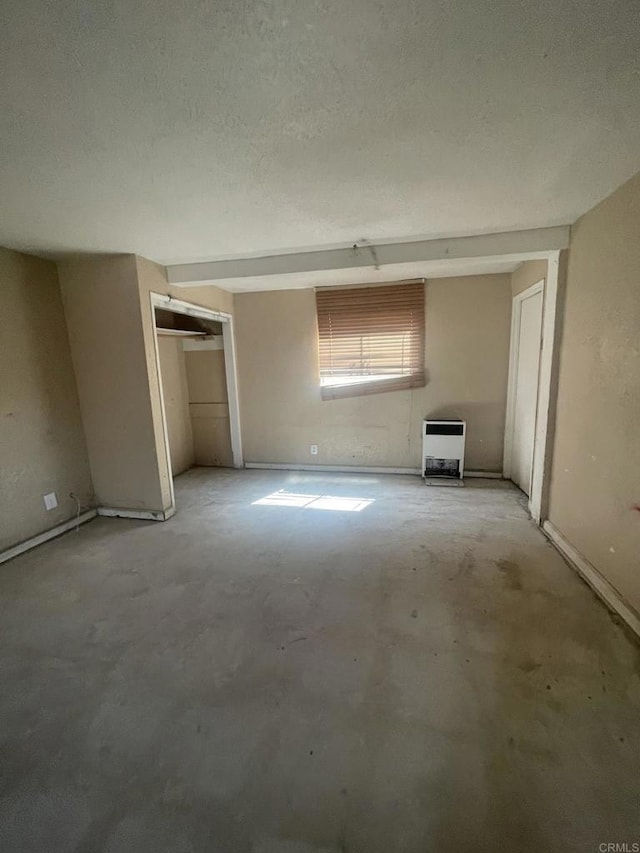 5412 Cervantes Ave, San Diego, CA 92114 - spare room with heating unit, unfinished concrete flooring, and a textured ceiling