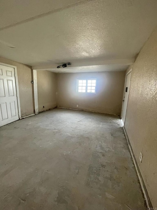 5412 Cervantes Ave, San Diego, CA 92114 - spare room with a textured wall, a textured ceiling, and concrete floors