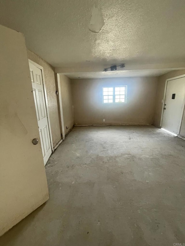 5412 Cervantes Ave, San Diego, CA 92114 - spare room with a textured ceiling and unfinished concrete floors