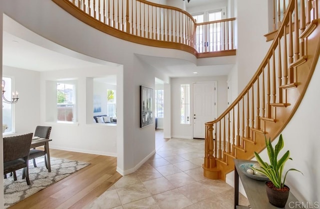 15240 Cayenne Creek Ct, San Diego, CA 92127 - foyer featuring stairs, healthy amount of natural light, a chandelier, a high ceiling, and light wood-type flooring