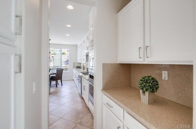 15240 Cayenne Creek Ct, San Diego, CA 92127 - kitchen with light tile patterned flooring, white cabinetry, decorative backsplash, appliances with stainless steel finishes, and recessed lighting