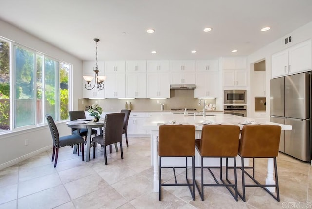 15240 Cayenne Creek Ct, San Diego, CA 92127 - kitchen featuring stainless steel appliances, a chandelier, light countertops, recessed lighting, and under cabinet range hood