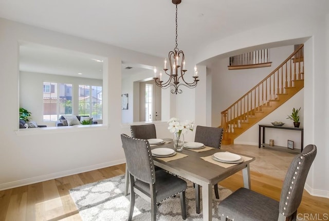 15240 Cayenne Creek Ct, San Diego, CA 92127 - dining space featuring stairs, wood finished floors, and a chandelier