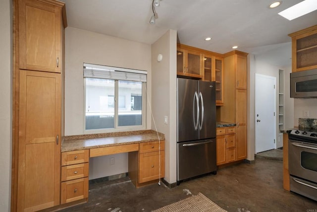 5155 W Point Loma Blvd Unit 9, San Diego, CA 92107 - kitchen featuring appliances with stainless steel finishes, glass insert cabinets, concrete floors, built in desk, and brown cabinets