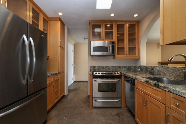 5155 W Point Loma Blvd Unit 9, San Diego, CA 92107 - kitchen featuring stainless steel appliances, concrete floors, brown cabinetry, arched walkways, and recessed lighting