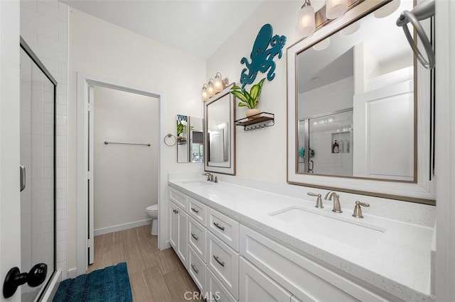 717 Lingel Dr, El Cajon, CA 92019 - full bathroom featuring a stall shower, double vanity, and wood finished floors
